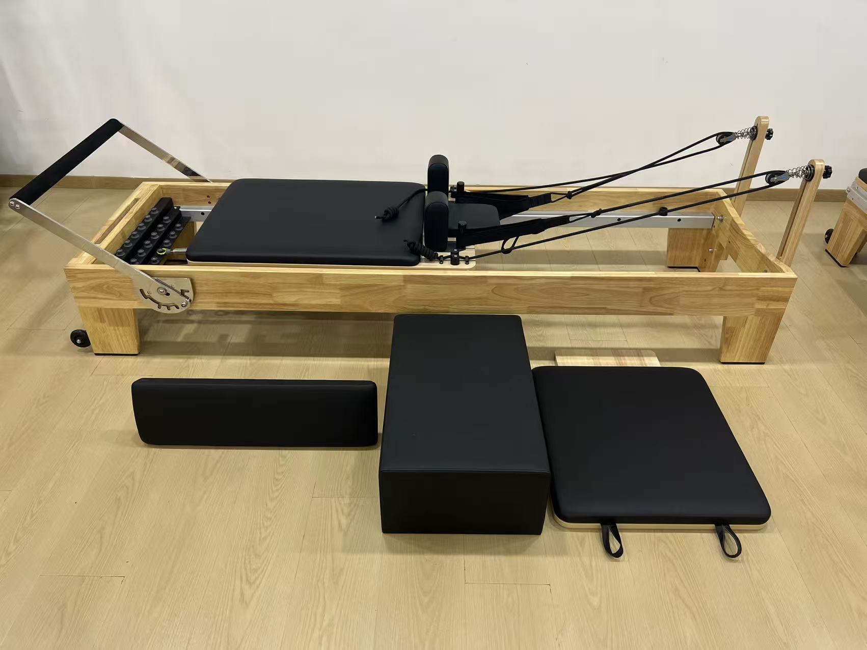 Oak Pilates reformer with full accessories photographed by Atuspilates